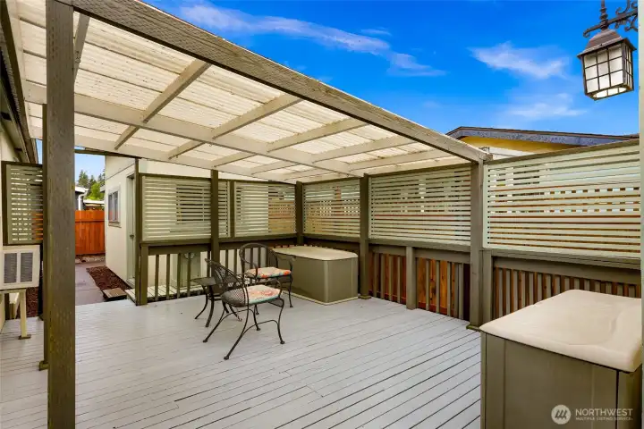 Surrounded by attractive privacy screening and conveniently located just off the kitchen, this inviting outdoor retreat offers both comfort and functionality