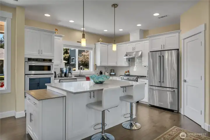 Gourmet Kitchen is bright, modern and features Stainless Steel appliances + Serving Island