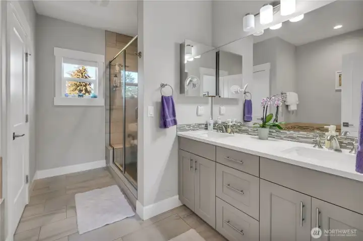 Primary EnSuite features a 5 Piece Bath with his/her vanity and wonderful natural stone surfaces