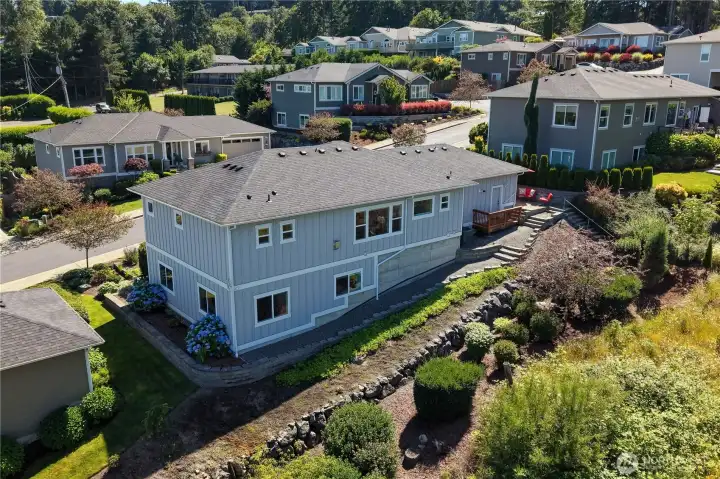 Backside view with low maintenance landscape and improved walkways around