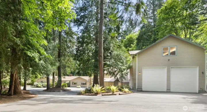 A private entrance opens to big bright wooded 2.5 acre lot!