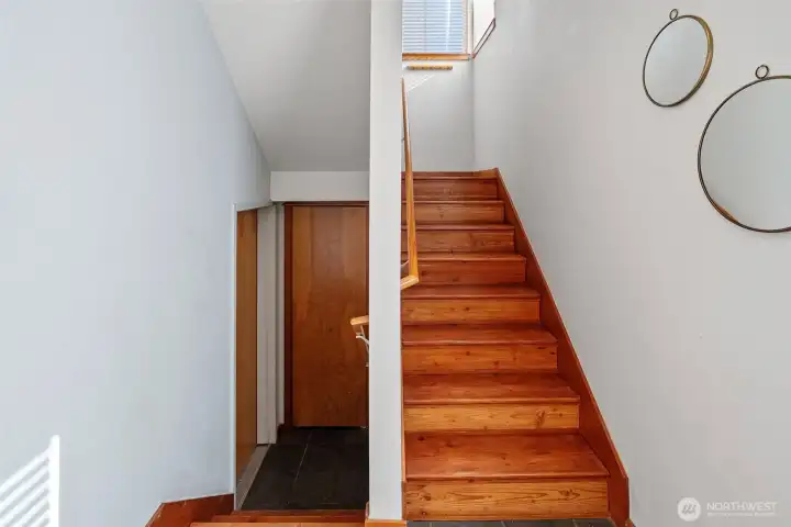 5. Attached garage access on the left and stairs to main living spaces on the right