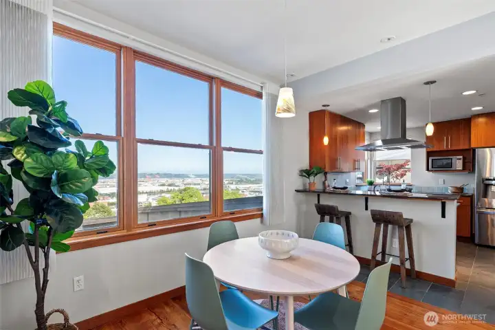 Dining area with sweeping port and city views