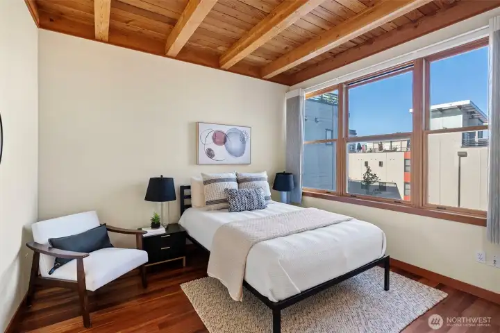 Primary bedroom with exposed wood ceiling