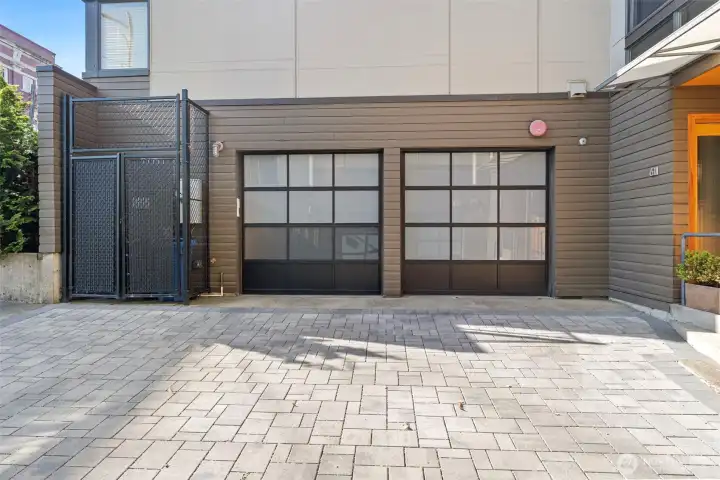 Two car garage and storage cage for garbage cans