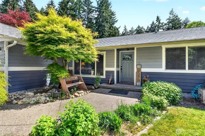 The front walk leads to a charming entry to the home
