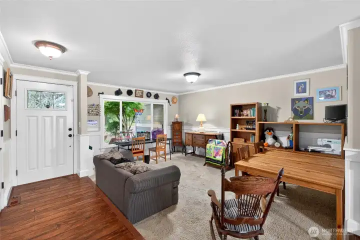 The entry opens to an over sized living room, currently used as a sewing and craft room
