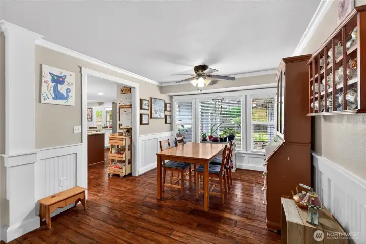 A dining room offers a sunny view of the back yard
