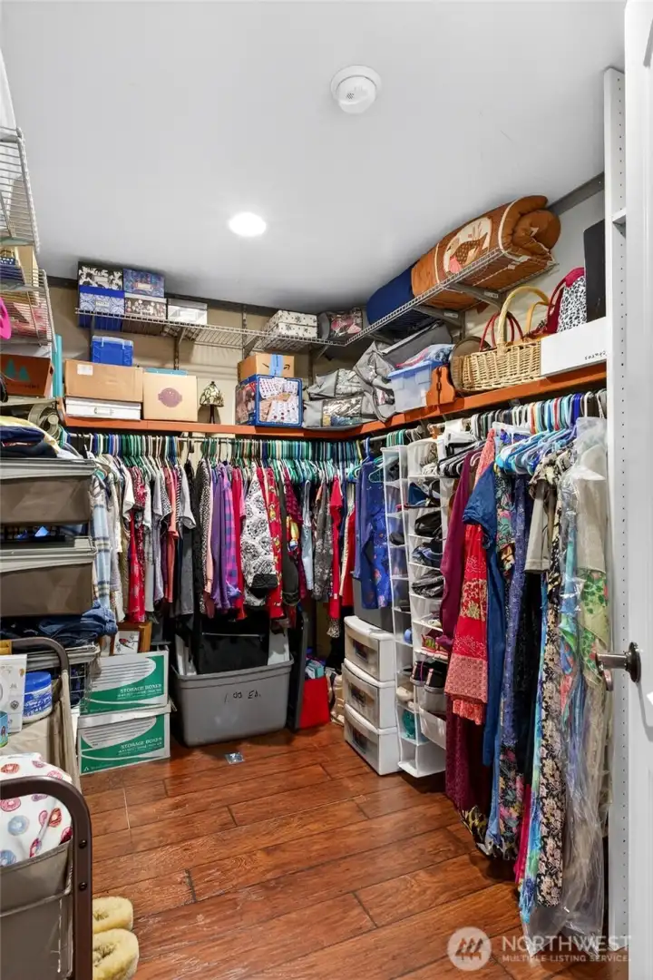 the primary bedroom walk in closet with thoughtfully designed organizers