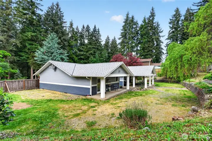 A nice mix of mature plantings and blank slate to create your own dream back yard