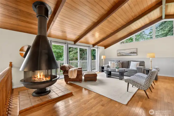 Enjoy cozy evenings around the fire in this open family room, with plenty of light, overlooking your property.