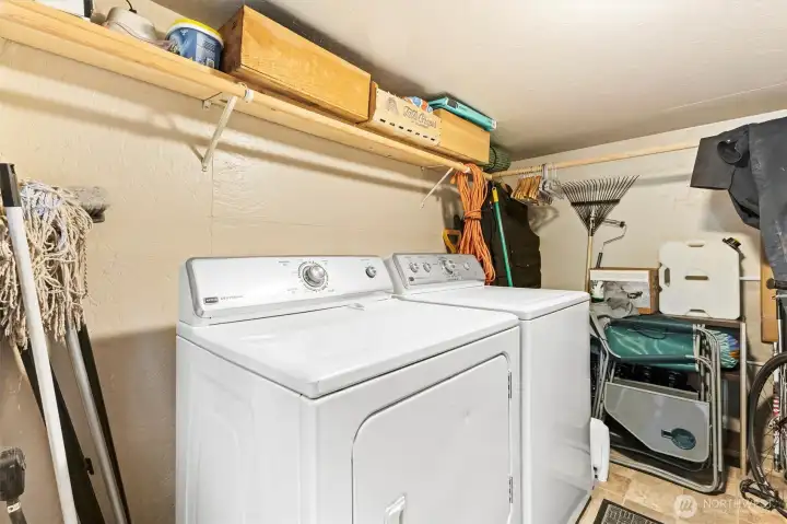 Dedicated laundry and storage area located in the detached outbuilding.
