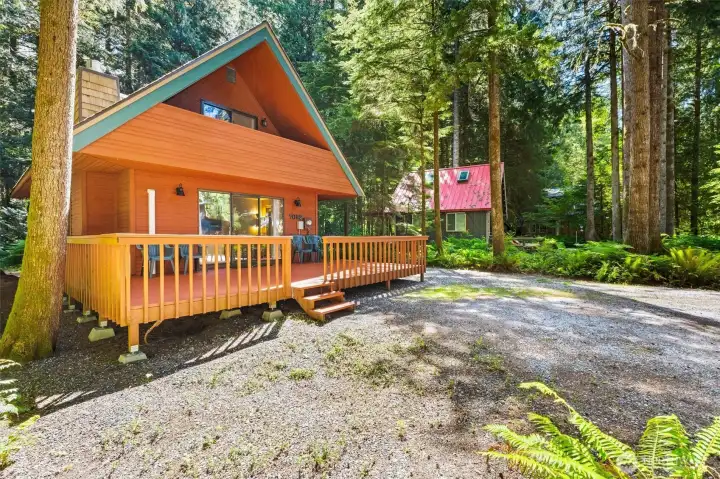 Exterior view showcasing the cabin's architecture and spacious deck.
