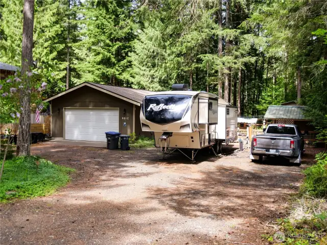 View of home from street with RV parked and hooked up to services. Tons of space!!!
