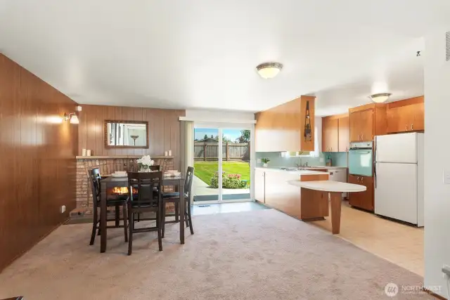 Adorable kitchen/dining with natural light peeping though backyard