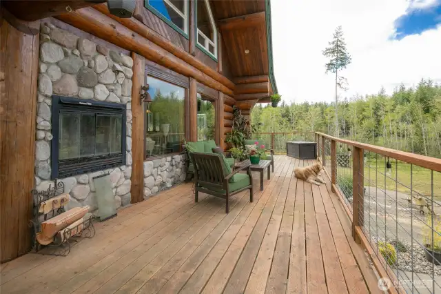 Part of the wraparound deck w/ wood stove to enjoy!