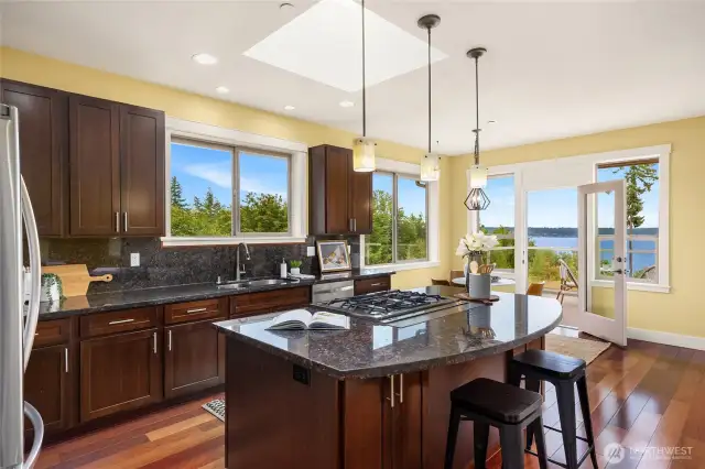 Stunning chef's kitchen with slab granite countertops, SS appliances and water views.