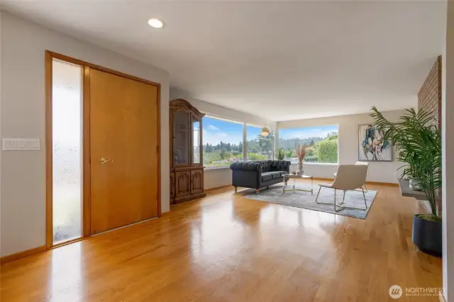 Beautiful hardwood flooring expands the living room, dining room, hallway, and main floor bedrooms.