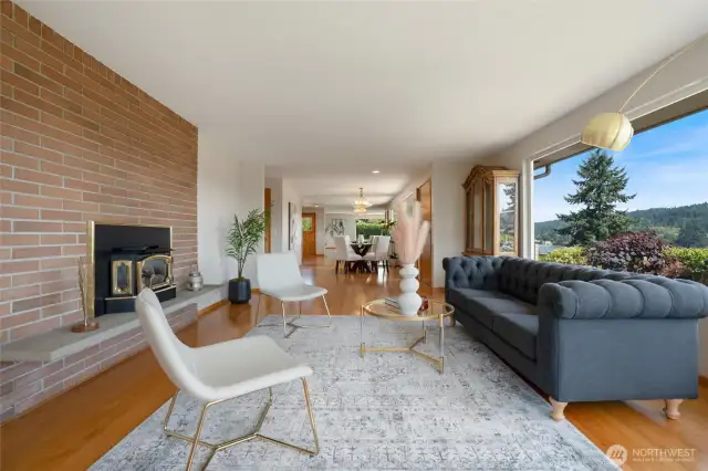 A gas fireplace keeps this home cozy on chilly Pacific Northwest days/nights. The expansiveness of this room reaches over to the dining room, creating a seamless flow between spaces perfect for both intimate gatherings and larger entertaining.