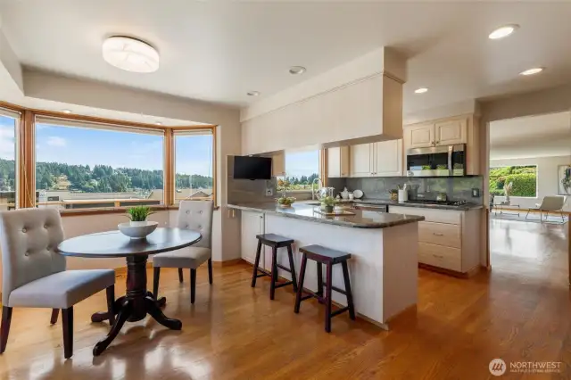 The Kitchen features granite countertops, an eating bar, and a breakfast nook. Outstanding views of Mt. Rainier can be enjoyed from here. Hardwood flooring extends into the kitchen from the living room and dining room, as well as into the hallway and all 3 bedrooms.