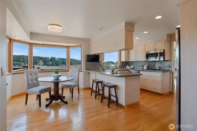 A bay window is a part of the nook area, and there is easy access to the front deck to watch the sunrise over Mt. Rainier from this room. The nook area provides a cozy and inviting space, enhanced by the natural light from the bay window, making it an ideal spot for morning views and relaxation.
