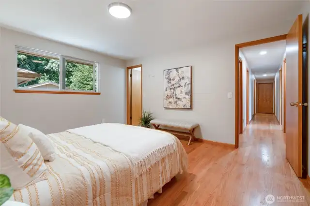 Another view from the primary bedroom with door to a private bathroom.