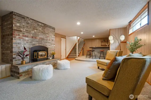 This lower-level bonus room enjoys a brick gas fireplace and is large enough for hosting ample gatherings.