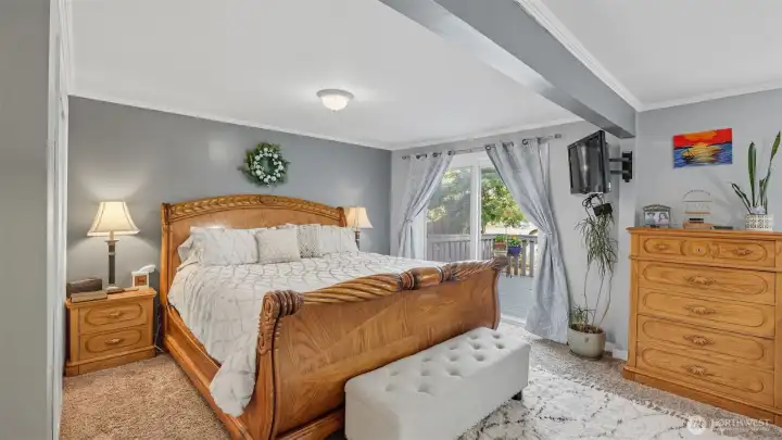 Retreat to this spacious & inviting primary suite with private deck access.