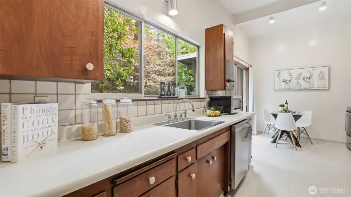 Warm sunlight and greenery create a fresh, inviting kitchen atmosphere.