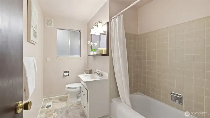 Bright and functional guest bath with a full tub/shower combo.