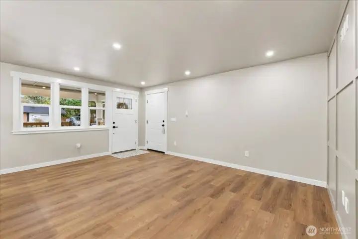 Welcome home! All those new windows are fully wrapped allow tons of natural light. LVP flooring is consistent through entire home