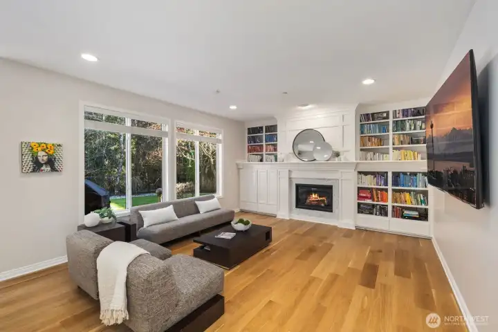 Remodeled fireplace with herringbone tile and built-in shelves