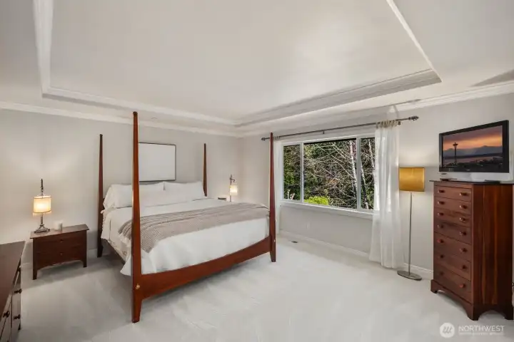 Primary bedroom with greenbelt views, new carpeting throughout the upstairs