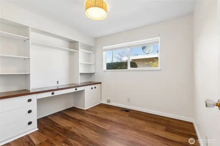 Bedroom with built in desk. Closet behind the door.