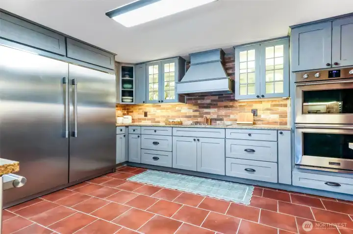 Commercial style fridge and double ovens for ease of entertaining.