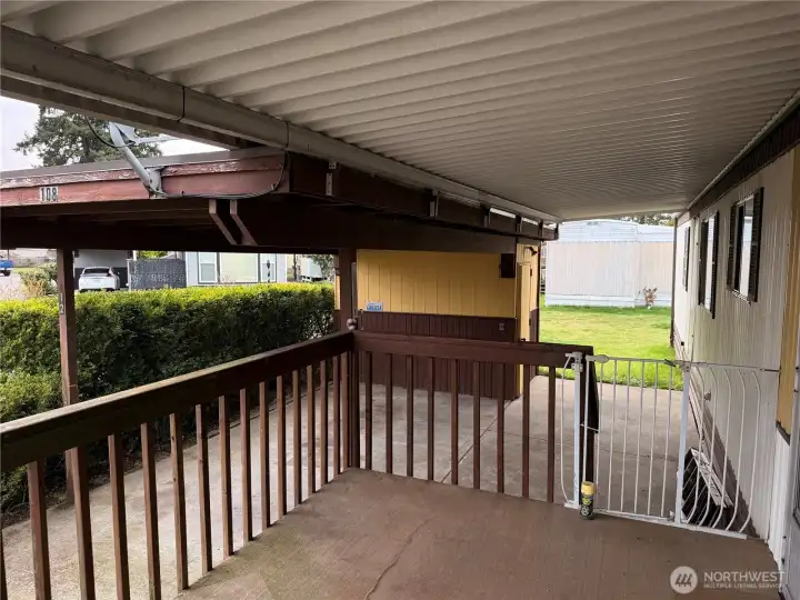 Nice covered deck entry view with carport and storage shed