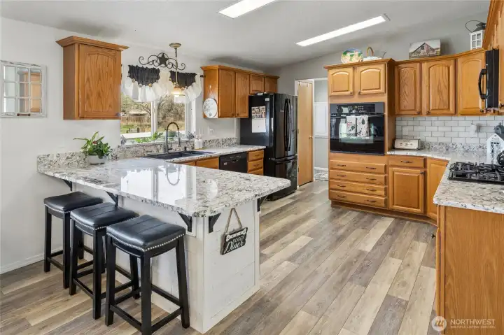 Fantastic kitchen with new beautiful granite  counters, new flooring, tons of cabinet and counter space and a GAS cook top - every chefs' favorite!