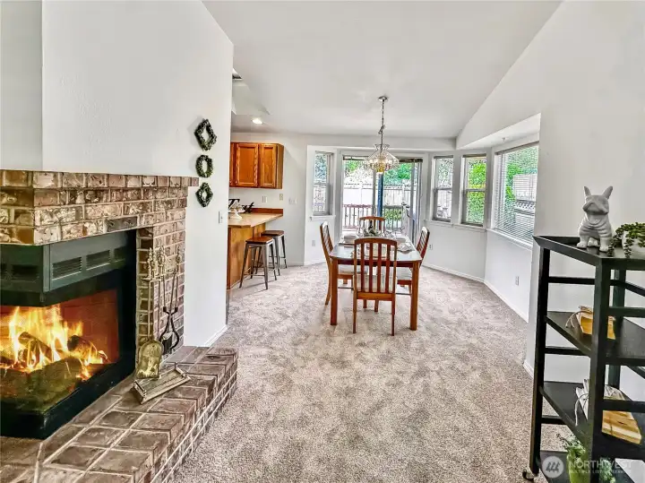 Looking toward the dining area from the living room.  The wood burning corner fireplace is perfect for those chilly spring mornings and cool nights.