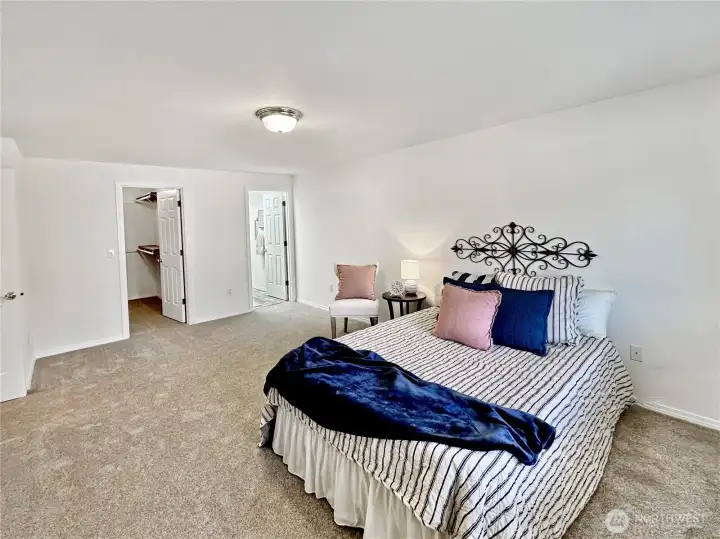 Ample primary bedroom with walk-in closet, new carpets and private 3/4 bath.