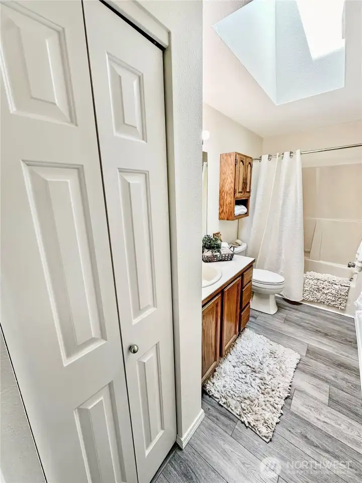Nice side linen closet in the wall bath.