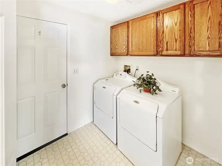 Laundry room with cabinets and easy access to the attached two car garage.