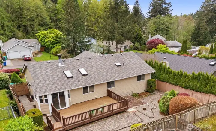 Back view of the home and lot.  Fenced rear yard, composite deck and low maintenance landscaping make this perfect space to relax.