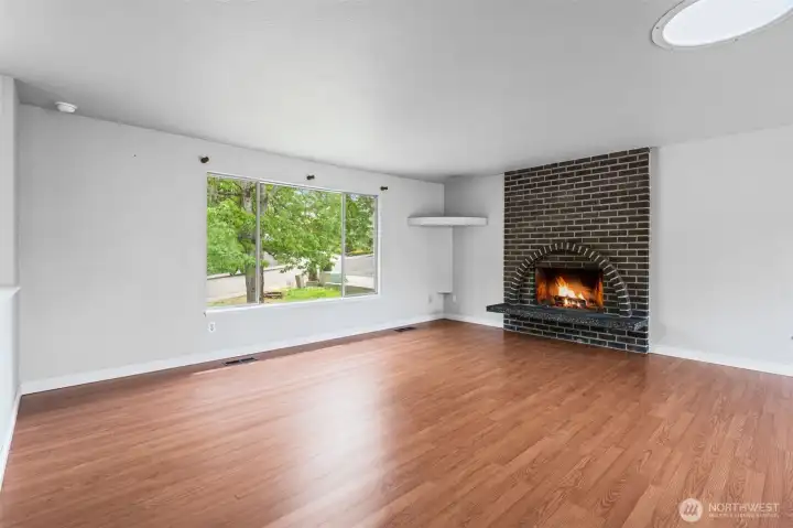 Classic brick fireplace, large picture window that lets in lots of light. Smooth ceilings and SolaTube brand skylight for nice, natural light!