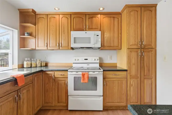 Solid oak cabinetry floor to ceiling — the storage infrastructure is already in place.