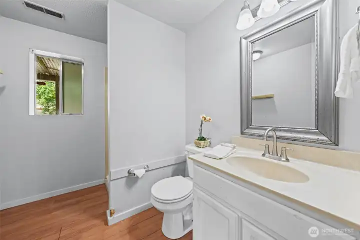 The lower-level ¾ bath features brushed nickel fixtures, warm laminate flooring, and a window that keeps the space feeling bright and open. When guests or renters stay downstairs, or the kids claim the lower level as their own, everyone has what they need without sharing a floor.