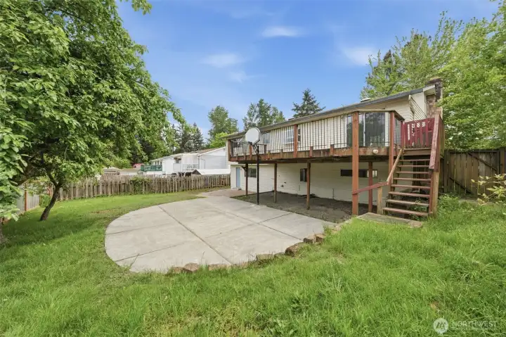 An elevated deck for summer evenings, a sport court for weekend games, a private lower-level entry for guests, and towering Pacific Northwest trees giving you the privacy you actually want. This backyard works as hard as you do.