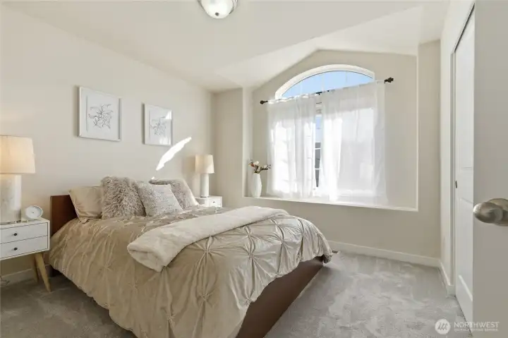 Additional bedroom with arched window.