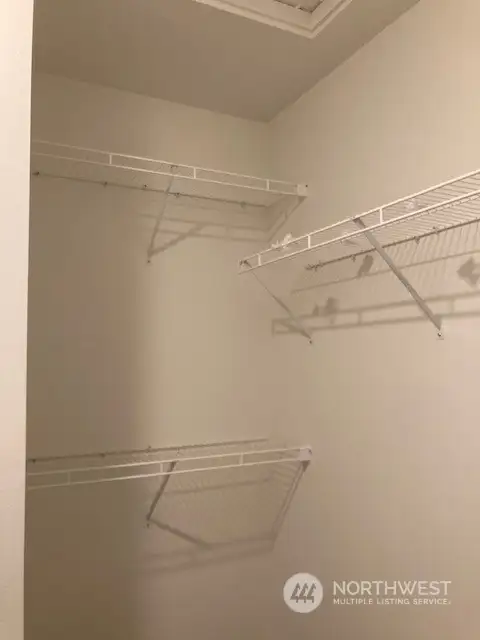 Walk-in closet has racks.