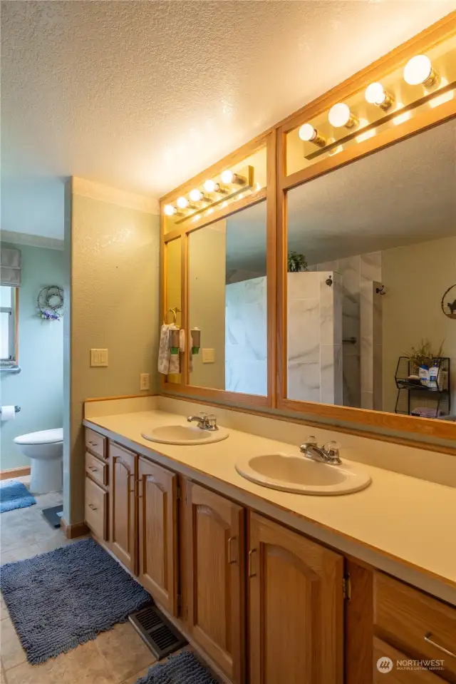 Primary bathroom with large tile walk in shower.