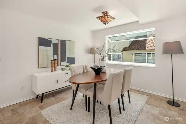 Dining room that opens to the livingroom. Note that the light fixture is excluded from the sale.